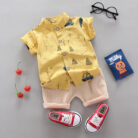 A happy child wearing a comfortable toddler boy cotton 2 piece outfit for everyday play from K&K Trend Wear.
