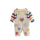 An adorable little boy ready for a party wearing a toddler boy overalls and shirt set from K&K trend Wear.