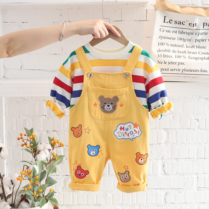 An adorable little boy ready for a party wearing a toddler boy overalls and shirt set from K&K trend Wear.