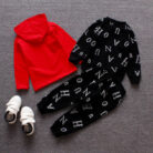 A happy child wearing a comfortable kids 2 piece long sleeve outfit for everyday play from K&K Trend Wear.