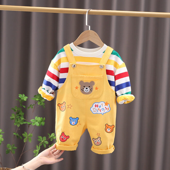 An adorable little boy ready for a party wearing a toddler boy overalls and shirt set from K&K trend Wear.