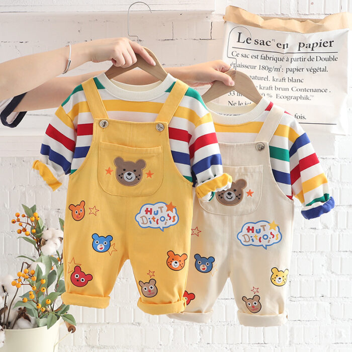 An adorable little boy ready for a party wearing a toddler boy overalls and shirt set from K&K trend Wear.