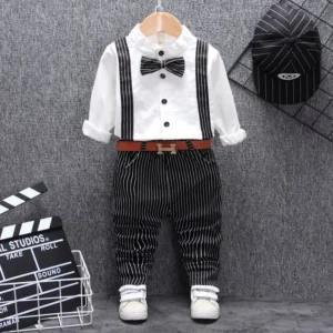 A handsome little boy ready for a special occasion wearing a toddler boy formal suspender outfit from K&K Trend Wear.